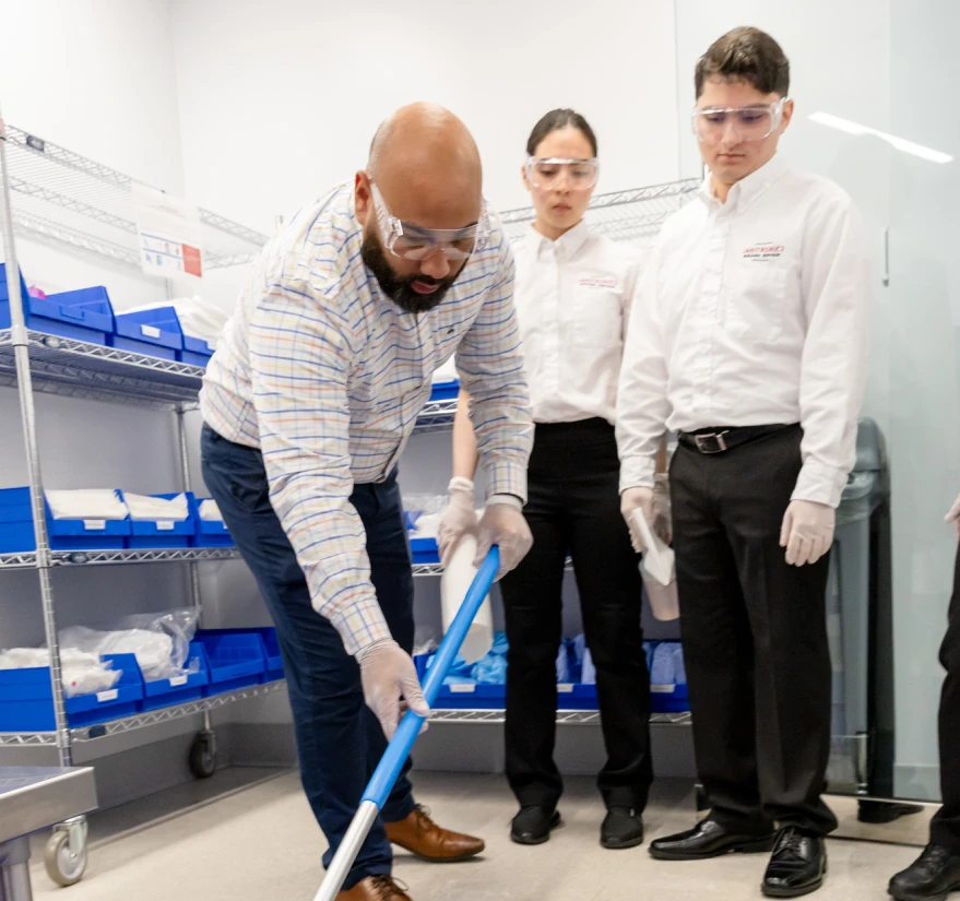 Janitorial training session with staff learning correct floor cleaning procedures