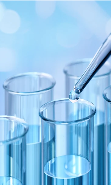 Laboratory pipette dispensing droplets into a row of transparent test tubes